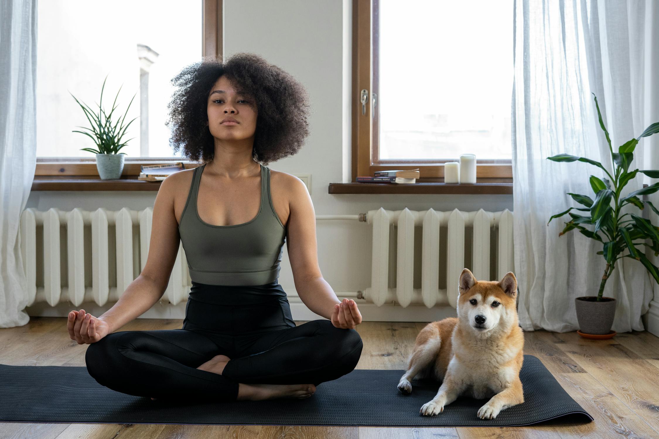 Person practicing yoga in a minimal concrete studio